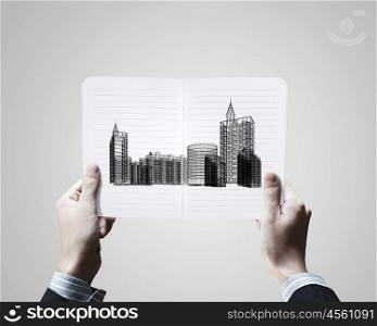 Construction concept. Conceptual image of male hands holding opened book