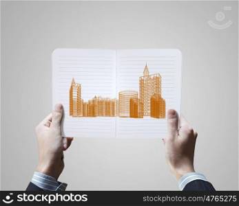 Construction concept. Conceptual image of male hands holding opened book