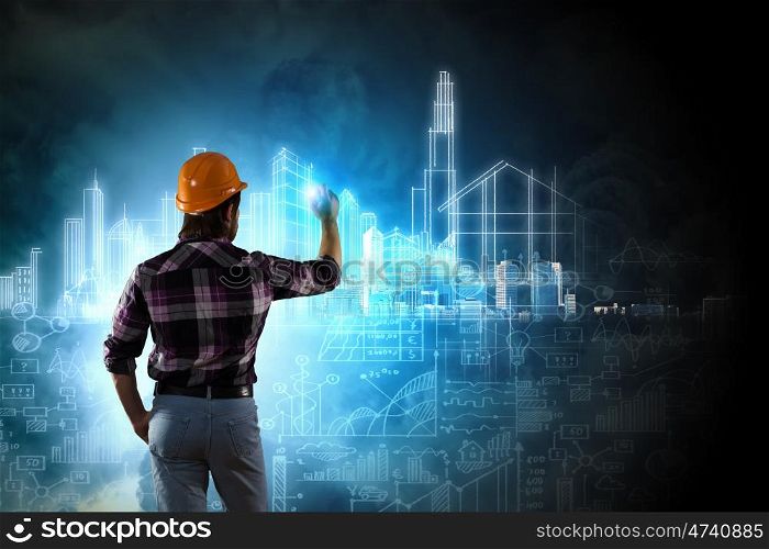Construction concept. Image of man builder drawing project sketch