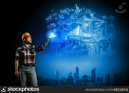 Construction concept. Image of man builder drawing project sketch