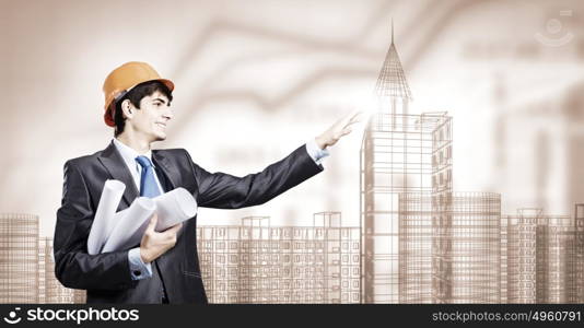 Construction concept. Young man engineer touching icon of media screen