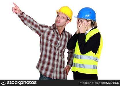 Construction couple discussing a problem