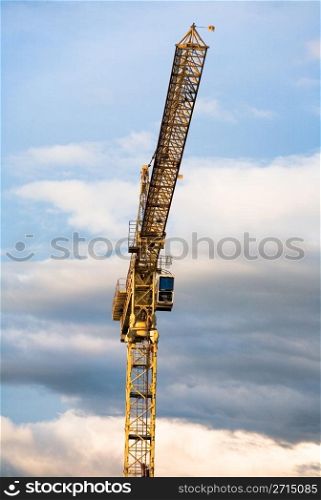 Construction crane against a clouded sky