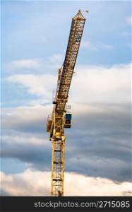 Construction crane against a clouded sky