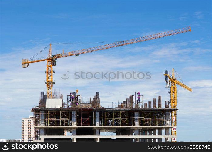 construction crane and worker of building industry with blue sky background