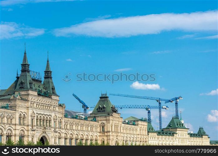 Construction cranes above the GUM building. State Department Store, Moscow, Russia.