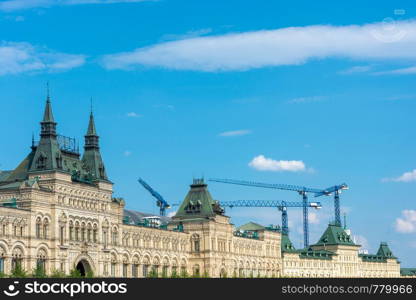 Construction cranes above the GUM building. State Department Store, Moscow, Russia.