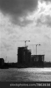 Construction Cranes and Buildings Silhouetted against sky in Black and White