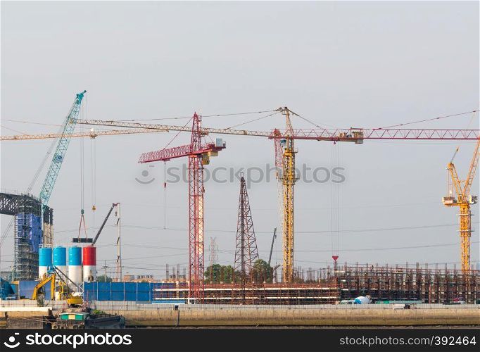 Construction cranes in building construction. Construction work that uses a crane to build a large building