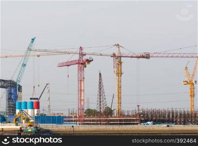 Construction cranes in building construction. Construction work that uses a crane to build a large building