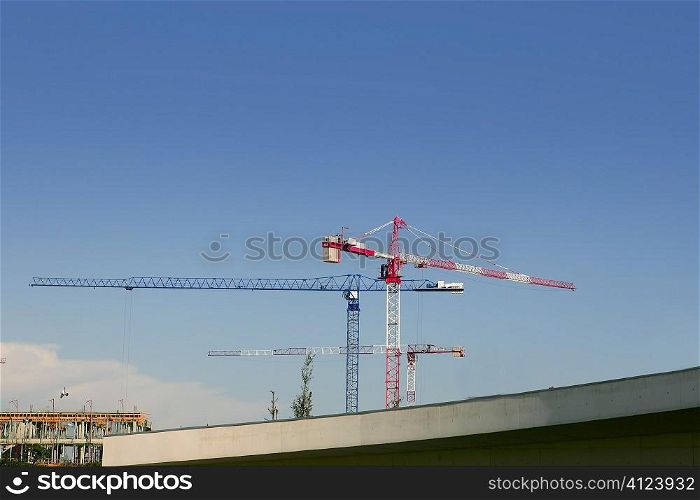 Construction cranes view over blue sky in Spain