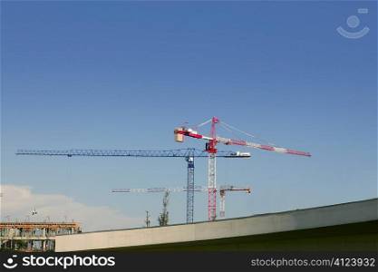 Construction cranes view over blue sky in Spain