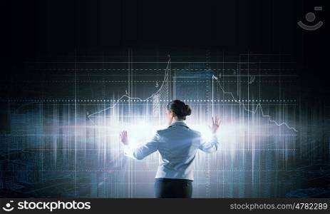 Construction design. Back view of businesswoman working with virtual panel