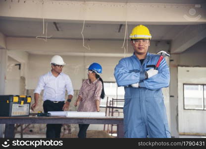 Construction engineer teamwork Safety Suit Trust Team Holding White Yellow Safety hard hat Security Equipment on Construction Site. Hardhat Protect Head for Civil Construction Engineer Concept