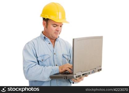 Construction engineer using his laptop computer on the job. Isolated on white.