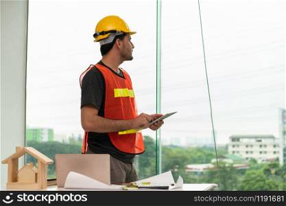 Construction engineer worker working in office. Real estate building contractor business concept.