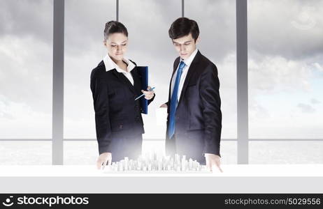 Construction engineering. Two business people examining design of construction model