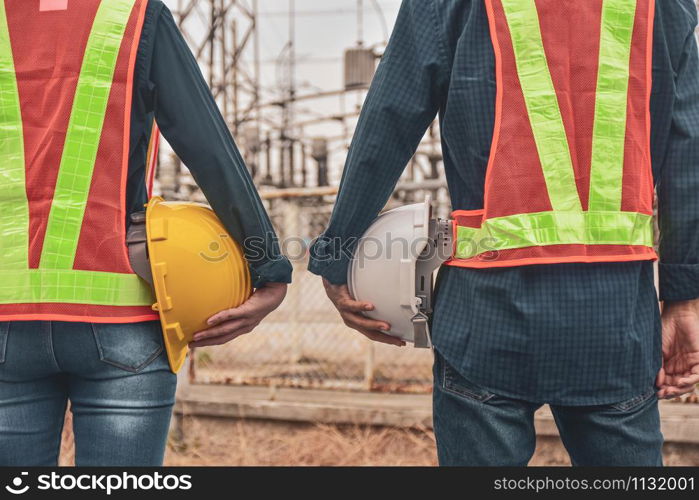 Construction Engineering two people holding helmet hard hat safety work building industrial