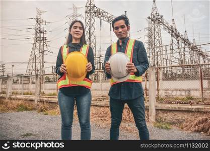 Construction Engineering two people holding helmet hard hat safety work building industrial