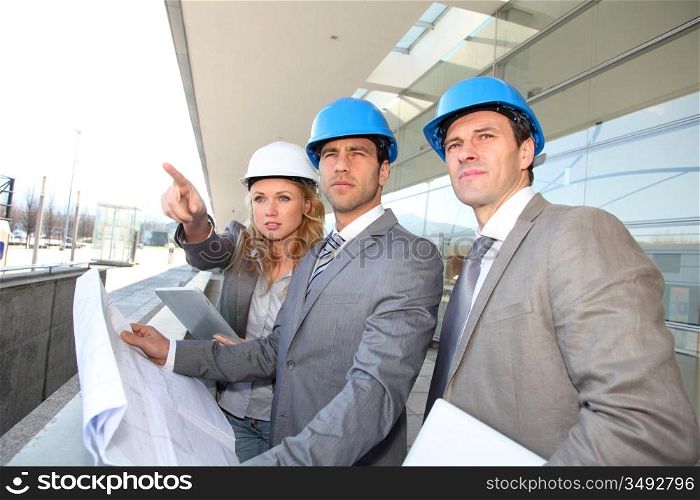 Construction engineers checking building site