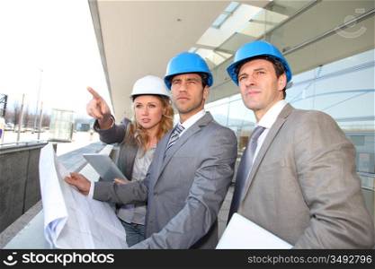 Construction engineers checking building site