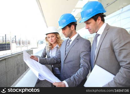 Construction engineers checking building site