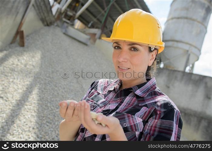 construction factory with female engineer checking gravel