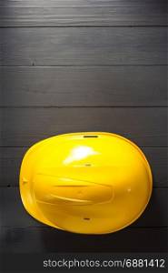construction helmet on wooden background