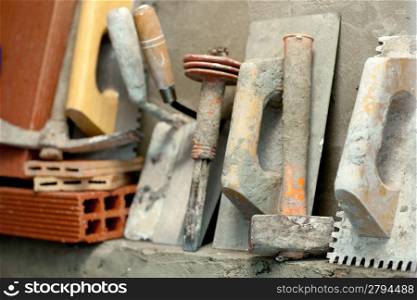 Construction mason cement mortar tools in a row