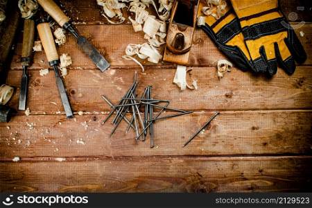 Construction nails on the table. On a wooden background. High quality photo. Construction nails on the table.