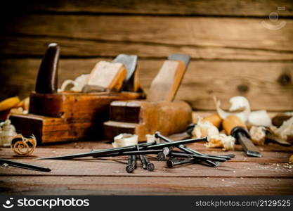 Construction nails on the table. On a wooden background. High quality photo. Construction nails on the table.