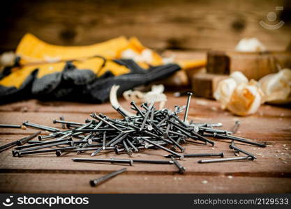 Construction nails on the table. On a wooden background. High quality photo. Construction nails on the table.