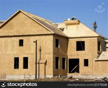 Construction of a new home with workers on roof