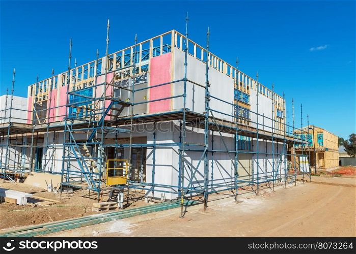 construction of a new housing estate, new homes in the scaffolding in the process of construction phase