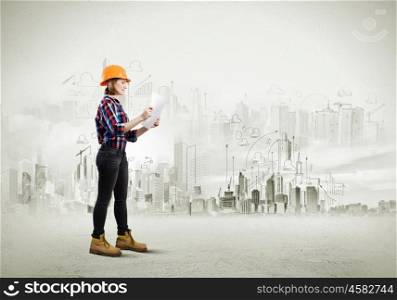 Construction plan. Image of young woman engineer with project against sketch background