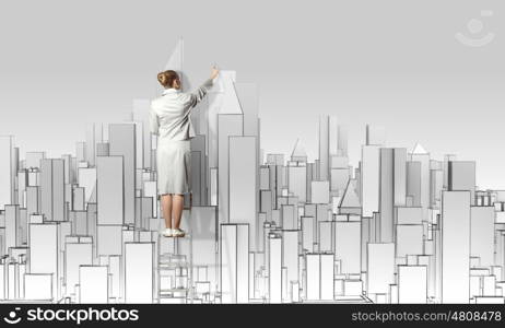 Construction project. Businesswoman standing on ladder with back and drawing project of city