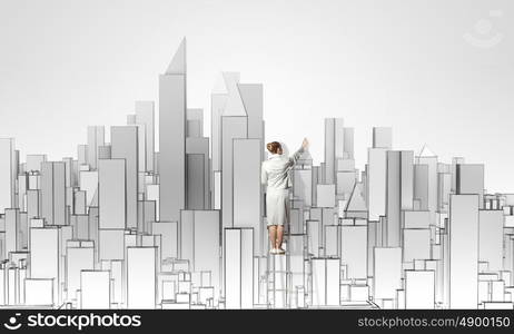 Construction project. Businesswoman standing on ladder with back and drawing project of city