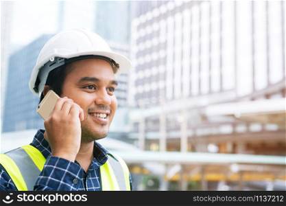 Construction project manager is calling workers.
