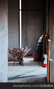 Construction pushcart or wheelbarrow in building hallway with natural light