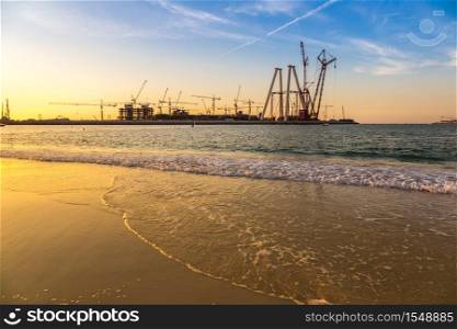 Construction site in Dubai at the sea sunset