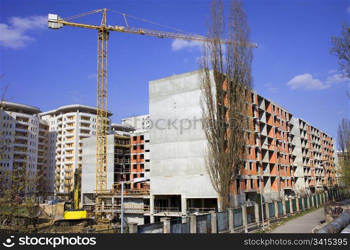 Construction site of an apartment block with concrete frame and brick walls