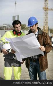 construction site supervisors looking at a blueprint
