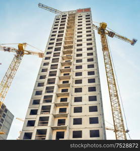 Construction site with buildings and industrial cranes