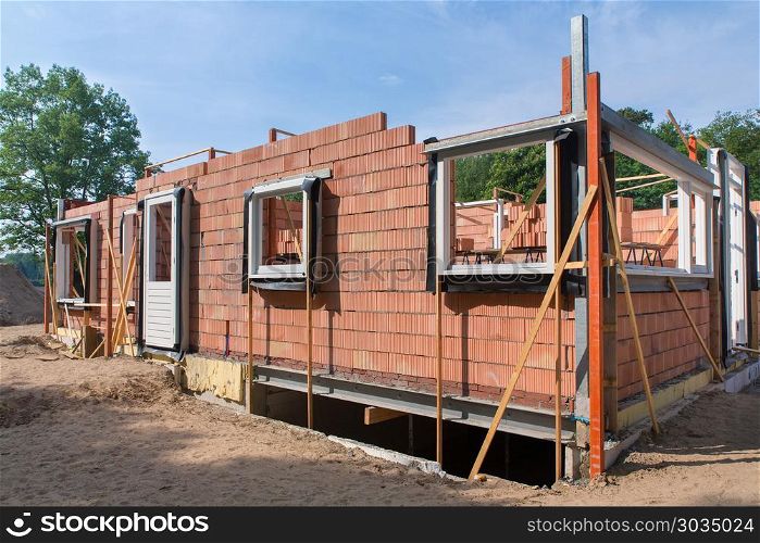 Construction site with new house. Construction site with walls and windows of new home