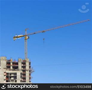 Construction site with two cranes against the sky