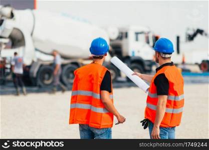 Construction site workers with plans