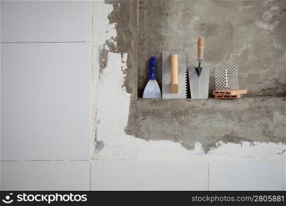 construction stainless steel trowel tools and spatula on cement mortar wall