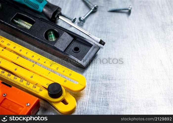 Construction stapler on the table. On a gray background. High quality photo. Construction stapler on the table.