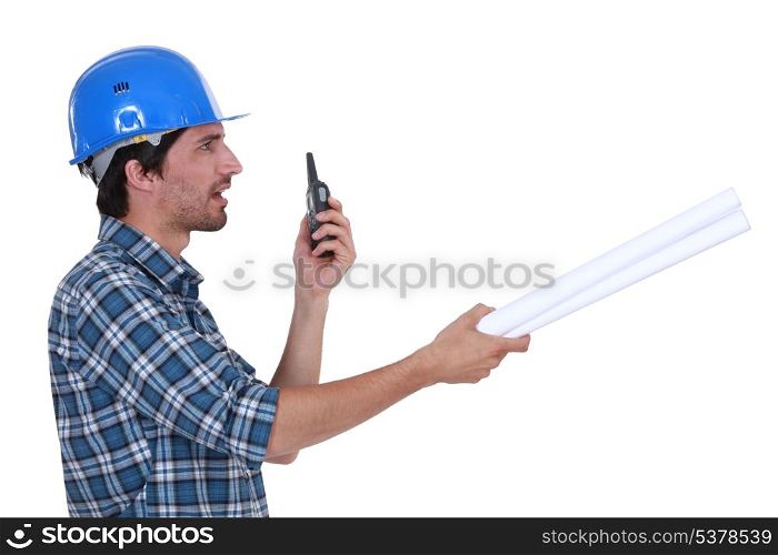 construction supervisor talking on his walkie talkie