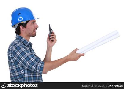construction supervisor talking on his walkie talkie